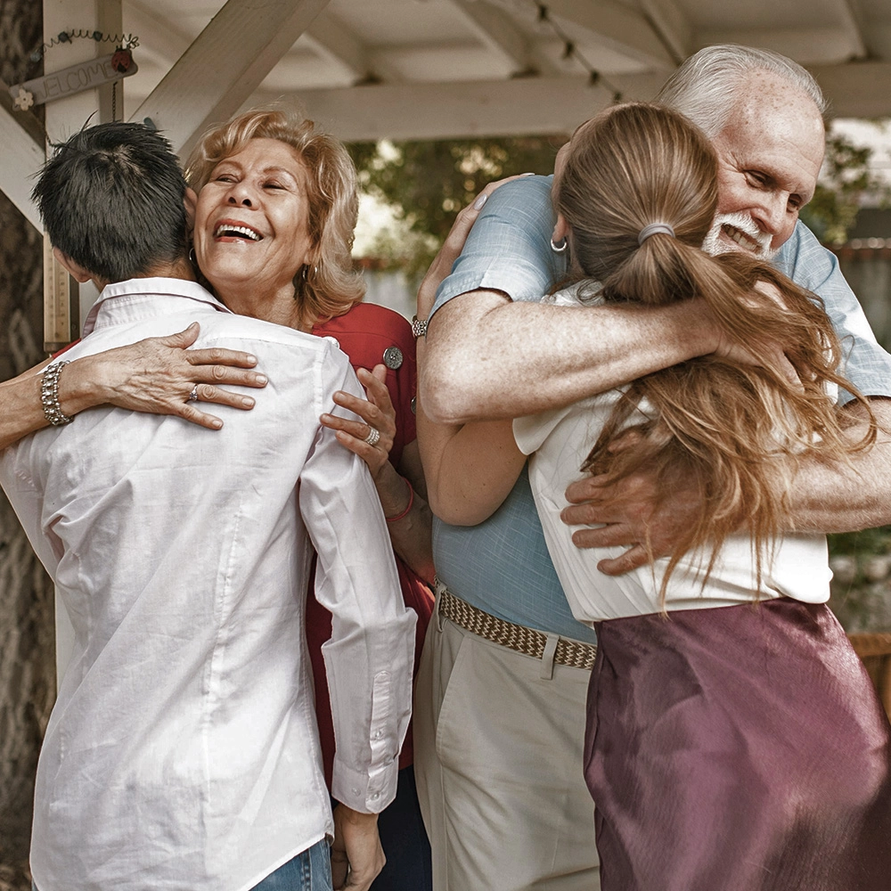 Family hugging and smiling